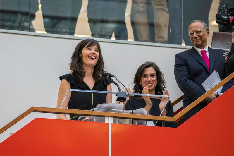 New York Times staff writers Megan Twohey, left, and Jodi Kantor address colleagues in the newsroom in New York after the team they led won the 2018 Pulitzer Prize for Public Service on Monday, April 16, 2018. The Times shared the prize with Ronan Farrow of The New Yorker for their reporting on sexual harassment that ushered in a reckoning about the treatment of women by powerful men in the uppermost ranks of Hollywood, politics, media and technology. New York Times Executive Editor Dean Baquet looks on at right. (Hiroko Masuike/The New York Times via AP)