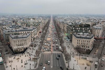 Traffic passes along the Avenue des Champs-Elysees as commercial and residential property sits on the city skyline in Paris, France, on Wednesday, Jan. 25, 2017. French Finance Minister Michel Sapin said the time has come for Britain to begin negotiations on leaving the European Union and that France wants its neighbor to state its plans.