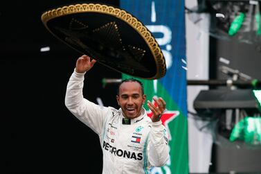 Mercedes driver Lewis Hamilton throws a Mexican Charro hat to the crowd as he celebrates his victory at the Mexico Grand Prix. AP Photo
