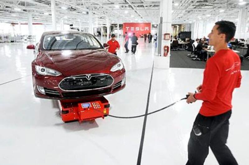 Mark Cuyler, an operations manager at Tesla, walks a Model S through the company's factory in Fremont, California, June 22, 2012. Tesla began delivering the electric sedan to customers on June 22.   REUTERS/Noah Berger   (UNITED STATES - Tags: TRANSPORT SCIENCE TECHNOLOGY BUSINESS) *** Local Caption ***  NB007_USA-_0622_11.JPG