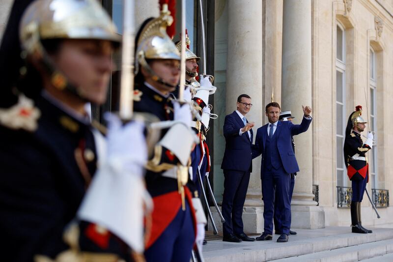 French President Emmanuel Macron welcomes Polish Prime Minister Mateusz Morawiecki as he arrives for a meeting at the Elysee Palace in Paris. Reuters