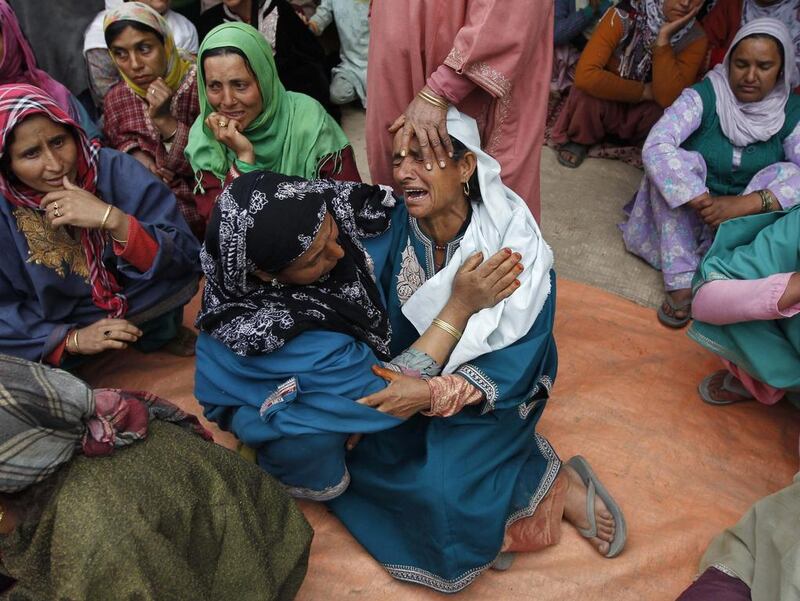 Relatives of Mushtaq Ahmad Mir, an Indian army soldier, mourn during his funeral in Qazipora in the Budgam district of Kashmir, India. Danish Ismail / Reuters