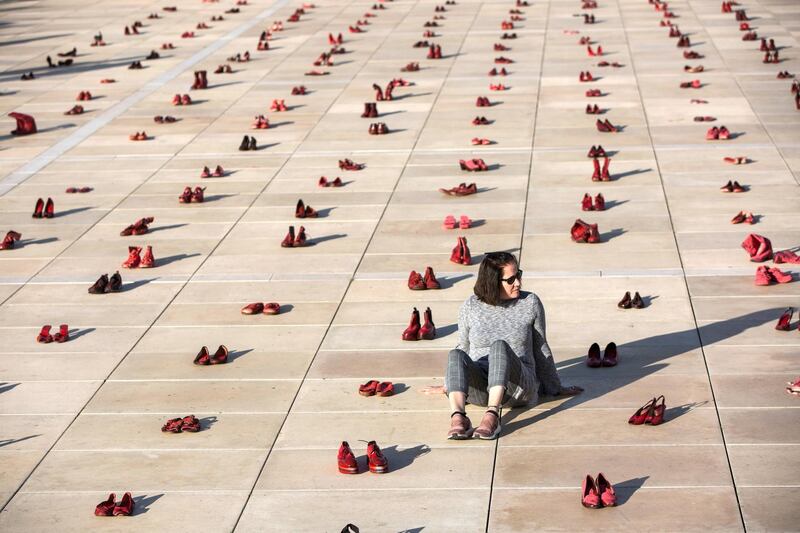 Hundreds of red shoes are displayed on the ground to  protest against violence toward women in Israel in Tel Aviv's  Habima Square on Dec. 4, 2018. A nationwide strike was held in protest of violence against all women Israel and a memorial for the 24 victims of domestic violence. Protestors called  on the government to take action against domestic abuse. (Photo by Heidi Levine/Sipa Press).