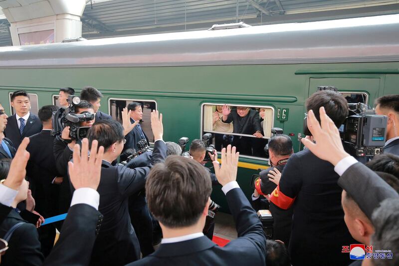 North Korean leader Kim Jong-un waves from a train  in Pyongyang, after returning from his unofficial visit to China. KCNA / via Reuters