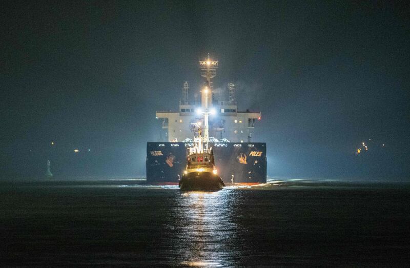 The cargo ship "Polesie" is guided into the harbour of Cuxhaven, northern Germany, on early October 25, 2023, after it collided with another cargo ship the "Verity" in the North Sea near the Heloland island, on October 24, 2023.  German rescue teams called off a search October 25, 2023 for four sailors missing after the Polesie sank after a collision between two vessels in the North Sea.  One person has already been declared dead and two people were rescued after the accident, which happened early October 24, 2023 about 22 kilometres (13 miles) southwest of the island of Helgoland.  (Photo by René Schröder  /  NEWS5  /  AFP)