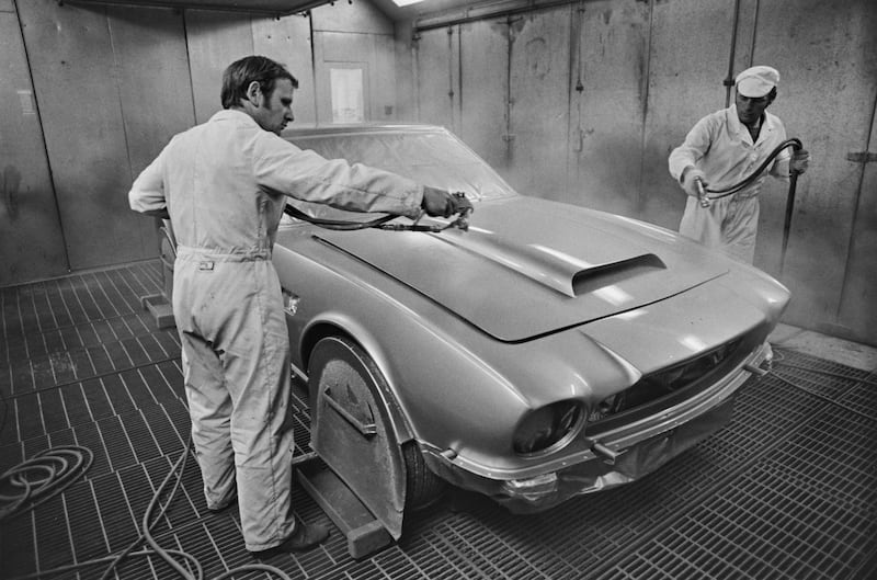 Workers spraying a new car at the Aston Martin plant in Buckinghamshire, 1974