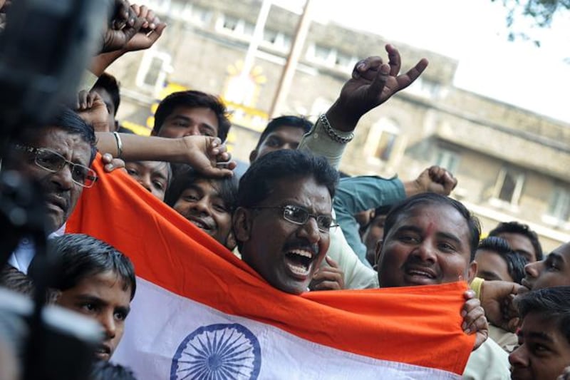 Indian people celebrate outside the high-security Yerwada Jail where Pakistan-born Mohammed Kasab, the sole surviving gunman of the 2008 Mumbai attacks was hanged, in Pune on November 21, 2012.   The sole surviving gunman from the 2008 Mumbai attacks was executed Wednesday, nearly four years after 166 people were killed in a three-day rampage through India's financial capital, officials announced.   AFP PHOTO

