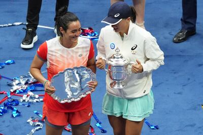 Jabeur (left) and Swiatek with their trophies. Reuters