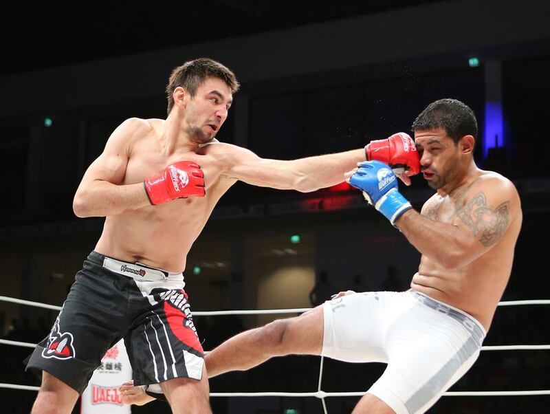 Jason Santana, of the US, in white shorts, fights with Pavel Gordeev from Russia in the Abu Dhabi Warriors 4 at IPIC Arena in Zayed Sports city in Abu Dhabi. Ravindranath K / The National