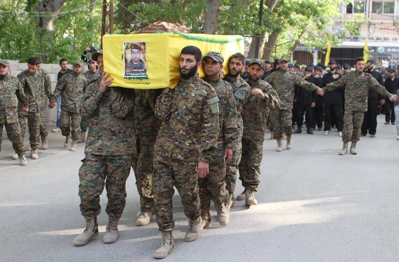 Hizbollah members carry the coffin of a fellow fighter at his funeral in the Bekaa valley in east Lebanon. Ahmad Shalha / Reuters