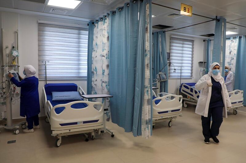 Palestinian medical staff are pictured in the newly opened Red Crescent Hospital dedicated to coronavirus, in the occupied-West Bank city of Nablus on January 16, 2021. - The Palestinian health ministry has recorded more than 102,000 cases coronavirus cases in the West Bank, including 1,164 deaths. (Photo by JAAFAR ASHTIYEH / AFP)