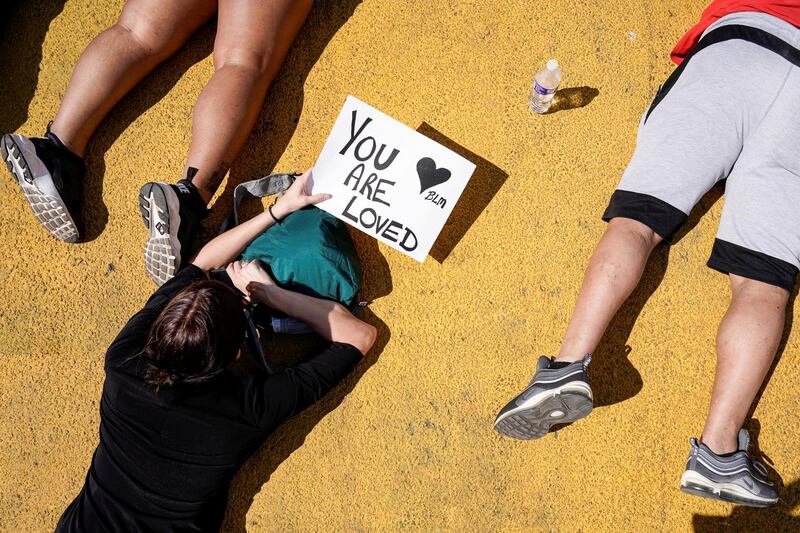 Protesters lie in the street during a rally against the death in Minneapolis police custody of George Floyd, near the White House in Washington DC. Reuters