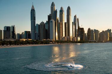 A jet ski races around in a circle as the Dubai Marina is seen in the background in Dubai, United Arab Emirates, Saturday, Dec. 21, 2019. (AP Photo/Jon Gambrell)