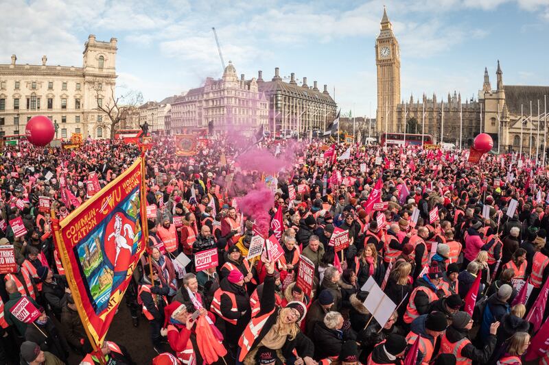 Striking mail workers and supporters gather in Parliament Square to listen to speeches by union leaders and representatives on Friday in London. Getty