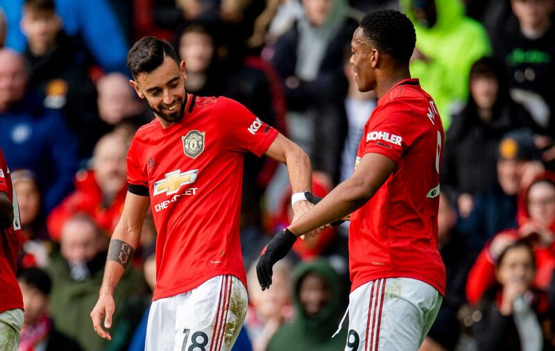 Manchester United's Bruno Fernandes, left, celebrates with Anthony Martial after scoring against Watford. EPA