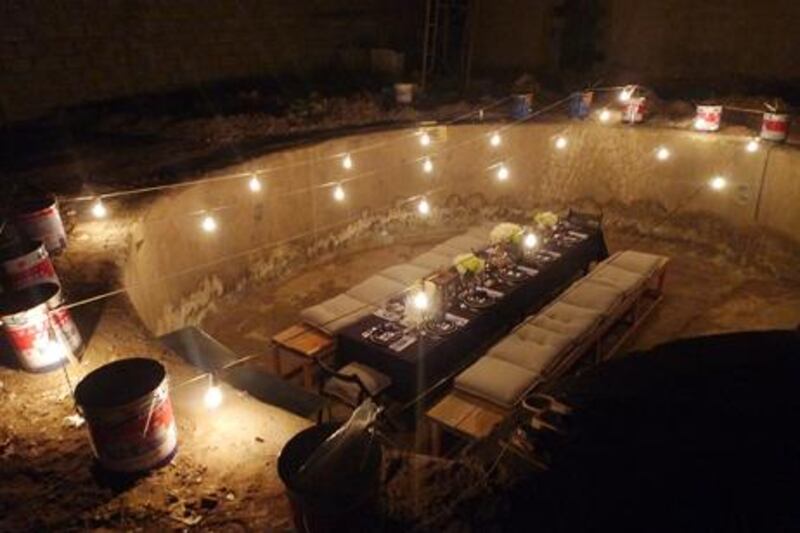 A dinner was held in an empty swimming pool, complete with custom-made benches.