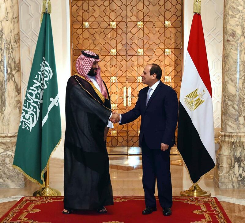 In this photo released by the Egyptian Presidency's office, Saudi Arabia's Crown Prince Mohammed bin Salman shakes hands with Egyptian President Abdel-Fattah El-Sissi in Cairo on Tuesday, Nov. 27, 2018. (Egyptian Presidency via AP)