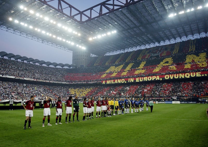 AC Milan and Internazionale players line-up in the San Siro stadium the clubs share before the Champions League semi-final first leg in 2003