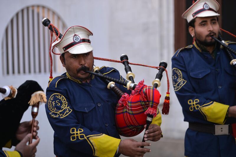 A Pakistani musical band perform with bagpipes made at the Mid East bagpipe factory. AFP.