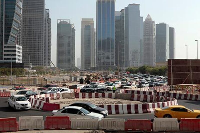 Dubai, United Arab Emirates - September 10, 2013.  Traffic building up as early as 8:30 am in this small temporary roundabout at the back of the JLT towers but slowly improving due to securities or traffic enforcers around the area, road construction in JLT is still ongoing.   ( Jeffrey E Biteng / The National )  Editor's Note;  Caline M reports.