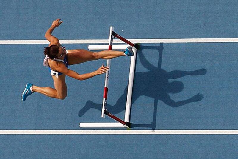 Hanna Titimets of Ukraine jumps a hurdle during the womenâ€™s 400 metres hurdles heats.

Pawel Kopczynski / Reuters