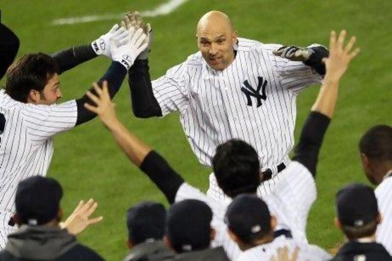 Pinch hit for a guy in the 600-home run club? That's what Yankees manager Joe Girardi did, sitting the struggling Alex Rodriguez for Raul Ibanez, centre, who rewarded Joe Girardi's gut feeling with not one but two home runs, the first to tie the game and the second, in the 12th inning, winning it. Ibanez became the first to enter a play-off game and homer twice in Major League Baseball history.