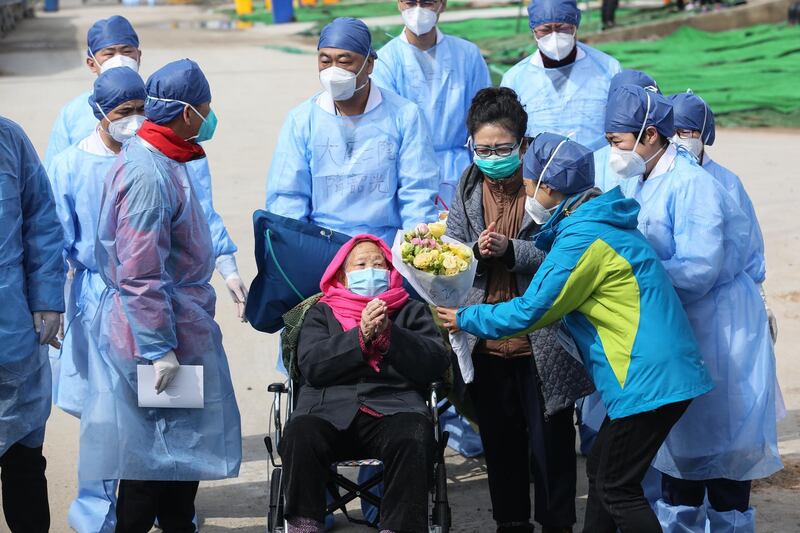 A recovered patient (in wheelchair), 98, is discharged from Leishenshan Hospital, the makeshift hospital for the COVID-19 coronavirus patients, in Wuhan in China's central Hubei province.  AFP
