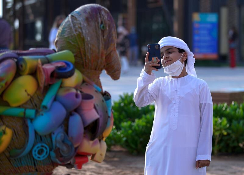 Abu Dhabi, United Arab Emirates, November 8, 2020.   The new Hudayriyat Leisure and Entertainment District at Hudayriyat Island.  A boy takes some photos of the many wildlife art works at the Marsana area.
Victor Besa/The National
Section:  NA
Reporter:  Haneen Dajani