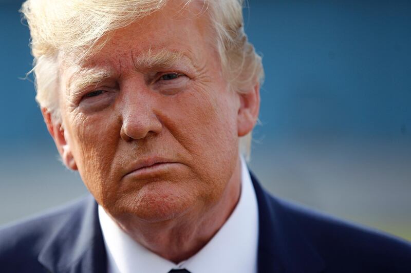 In this Aug. 18, 2019, photo, President Donald Trump speaks with reporters before boarding Air Force One at Morristown Municipal Airport in Morristown, N.J. (AP Photo/Patrick Semansky)