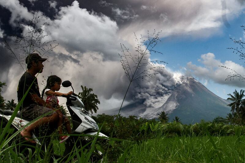 Thick smoke rises during an eruption from Mount Merapi, Indonesia’s most active volcano, as seen from Tunggularum village in Sleman on March 11, 2023.  (Photo by DEVI RAHMAN  /  AFP)