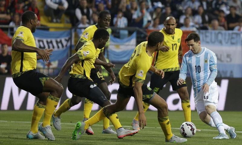 Lionel Messi dribbles into a crowd of defending Jamaica players during a Copa America group match in the summer. Natacha Pisarenko / AP / June 20, 2015