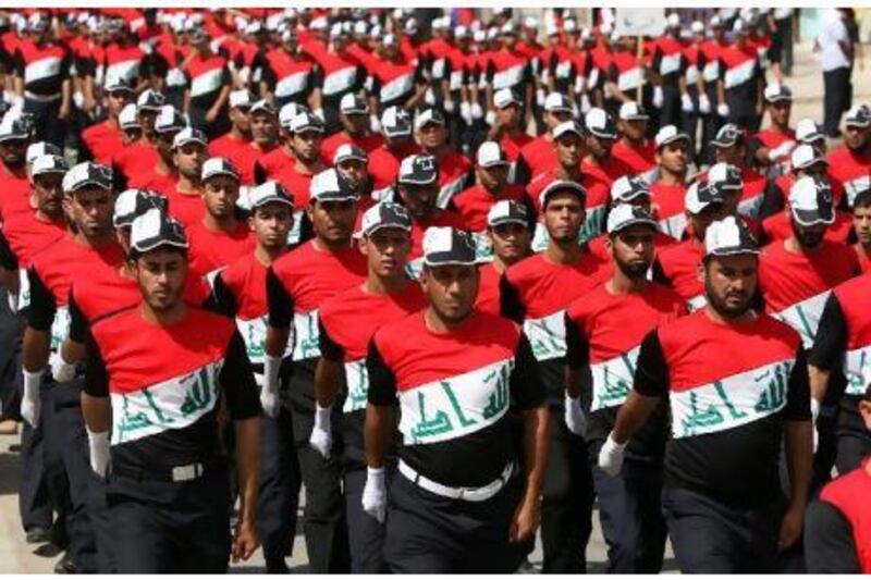 Members of the Iraqi Sadr Movement's Mahdi Army march in Baghdad's predominantly Shiite suburb of Sadr City during a parade demanding the withdrawal of US forces from Iraq. Ahmad Al Rubaye / AFP Photo