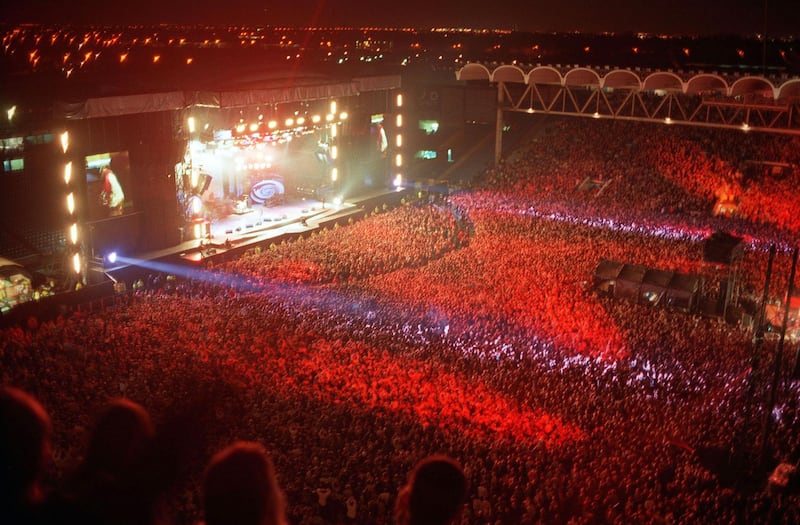 MANCHESTER - 1996: Oasis on stage at Manchester City's football ground, Maine Road. (Photo by Dave Hogan/Getty Images)