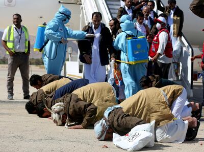 Freed Saudi-led coalition prisoners pray as they arrive after their release in a prisoner swap, at Sayoun airport, Yemen October 15, 2020. REUTERS/Ali Owidha