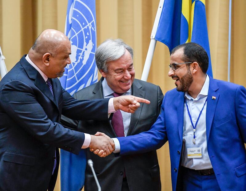 Head of delegation for rebel forces known as Houthis, Mohammed Amdusalem, right, and Yemen Foreign Minister Khaled al-Yaman, left, shake hands together with UN Secretary Geleral Antonio Guterres, during the Yemen peace talks closing press conference at the Johannesberg castle in Rimbo north of Stockholm, Sweden, Thurday Dec. 13, 2018. The United Nations secretary general on Thursday announced that Yemen's warring sides have agreed after week-long peace talks in Sweden to a province-wide cease-fire in Hodeida. (Pontus Lundahl/TT News agency via AP)