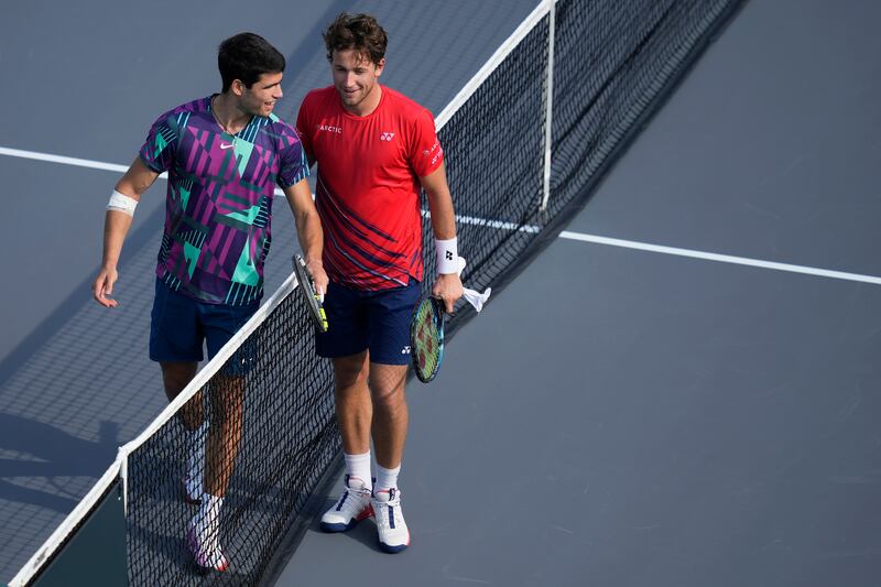 Carlos Alcaraz and by Casper Ruud at the net after the end of their match. AP