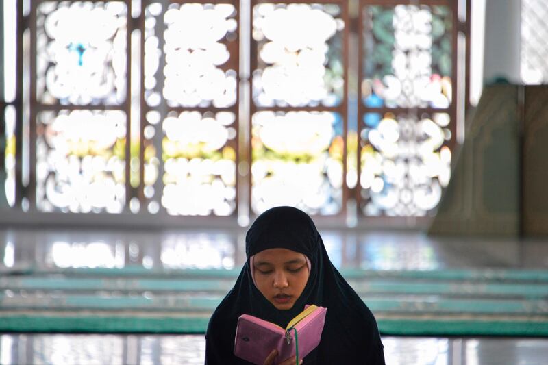 A Muslim woman reads the Koran at Baiturrahman grand mosque in Banda Aceh.  AFP