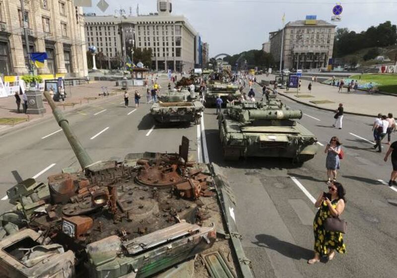 People visit central Kyiv, where destroyed Russian tanks are put on display. Getty Images