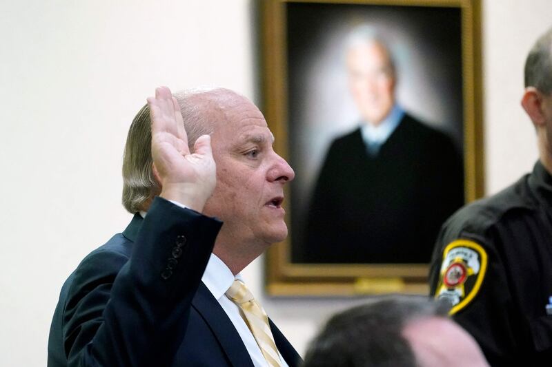 Richard Marks, a technical forensics expert, is sworn in before he testifies in the courtroom on Monday. AFP