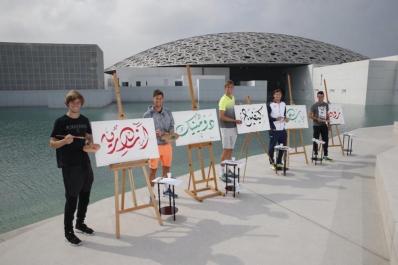 From left: Andrey Rublev, Dominic Thiem, Kevin Anderson, Pablo Carreno Busta and Roberto Bautista Agut try their hand at writing their names in Arabic calligraphy at the Louvre Abu Dhabi on Saadiyat Island. Rublev faces Bautista Agut in his opening match of the Mubadala World Tennis Championship at the International Tennis Stadium in Abu Dhabi on Thursday. Courtesy IPN
