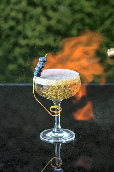 A drink - in a a gold-flaked glass, of course - gets the culinary torch treatment at Aer 