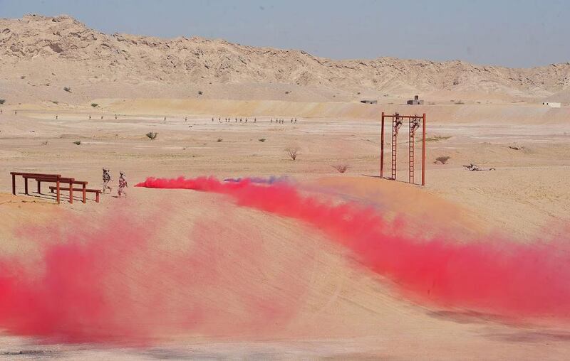 Servicemen take part in an obstacle course presentation at the graduation ceremony of the 33rd batch of university graduate officers at the Zayed II Military College in Al Ain on Tuesday.