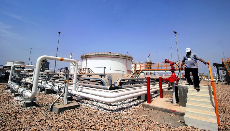 epa06691910 An Iraqi oil worker walks at the al-Siba Gas Field, 30kms south-east of Basra city, southern Iraq, 25 April 2018. The al-Siba field is the first field in Iraq for producing natural gas, which is being developed by Kuwait Energy company.  EPA/HAIDER AL-ASSADEE