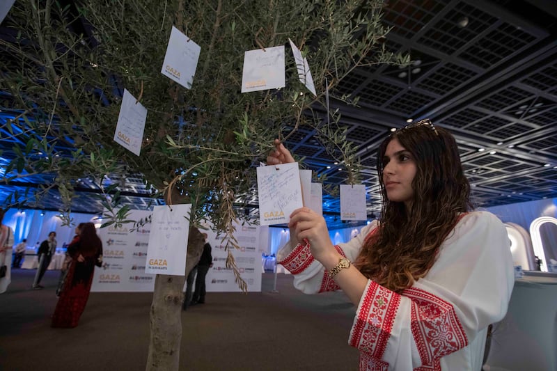 Guests write messages of support for Gaza at Dubai World Trade Centre. Leslie Pableo for The National