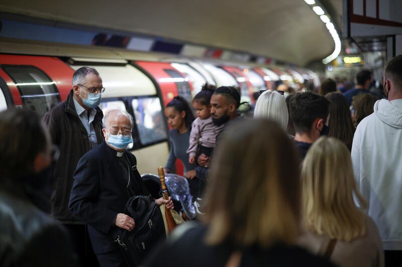 People walk along a platform at Leicester Square underground station in London.  Social distancing rules will be scrapped, face masks no longer compulsory, people no longer required to use QR codes and large events in full swing, with no intention to use vaccine passports.