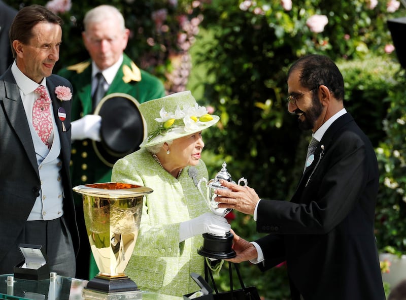 Horse Racing - Royal Ascot - Ascot Racecourse, Ascot, Britain - June 22, 2019   Britain's Queen Elizabeth presents Dubai's ruler Sheikh Mohammed bin Rashid al-Maktoum with a trophy for the winning owner of the 4.20 Diamond Jubilee Stakes   Action Images via Reuters/John Sibley