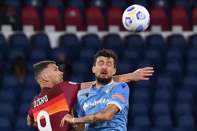 Roma's Bosnian forward Edin Dzeko and Lazio's Italian defender Francesco Acerbi go for a header. AFP