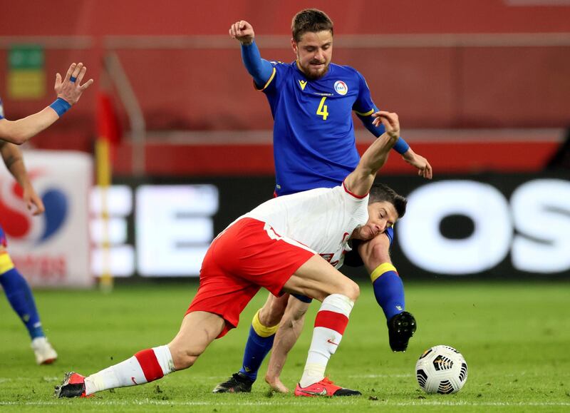 Robert Lewandowski under pressure from Andorra's Marc Rebes. EPA