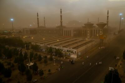 A sand storm engulfs Muslim pilgrims as they arrive at Namirah Mosque on Arafat Mountain, during the annual hajj pilgrimage, outside the holy city of Mecca, Saudi Arabia, Sunday, Aug. 19, 2018. More than 2 million Muslims have begun the annual hajj pilgrimage, representing one of the five pillars of Islam and is required of all able-bodied Muslims once in their life. (AP Photo/Dar Yasin)