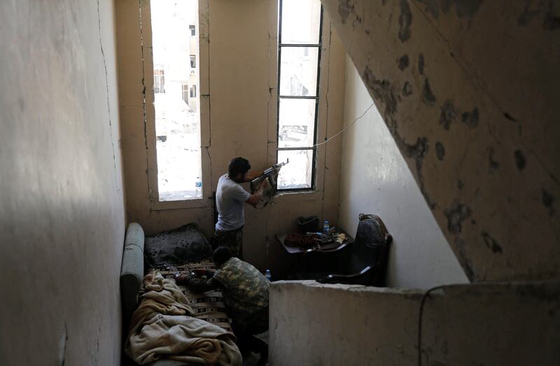 A fighter of the Syrian Democratic Forces fires his weapon towards the positions of ISIL fighters in the National Hospital, at the frontline in Raqqa, on October 8, 2017. Erik De Castro / Reuters